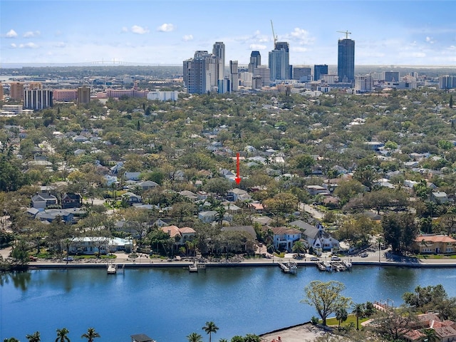 birds eye view of property featuring a water view and a city view