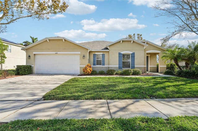 ranch-style house featuring a front yard and a garage