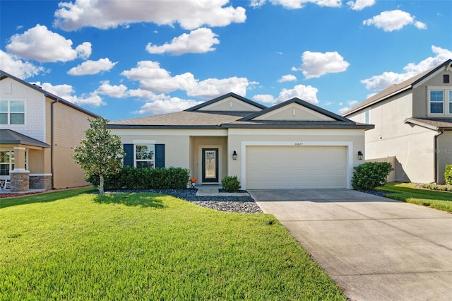 view of front of home with a front yard and a garage