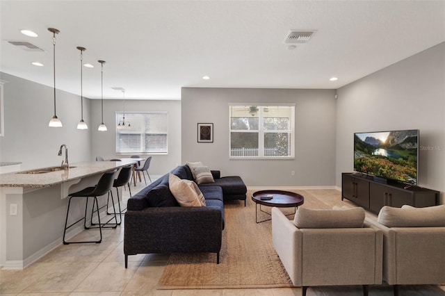 living room with sink and light tile patterned floors