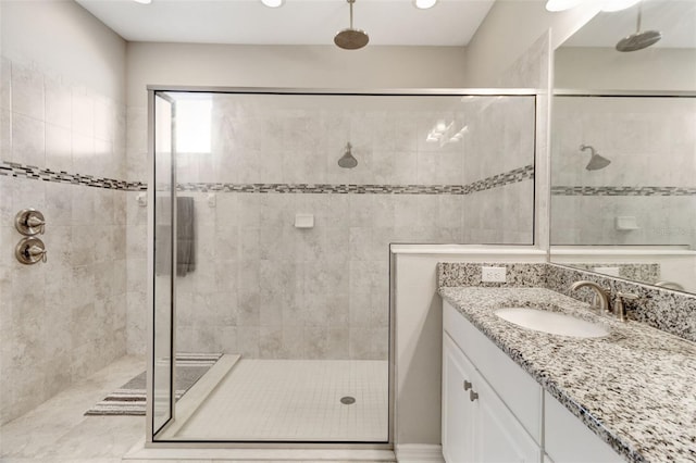 bathroom with vanity and a shower with shower door