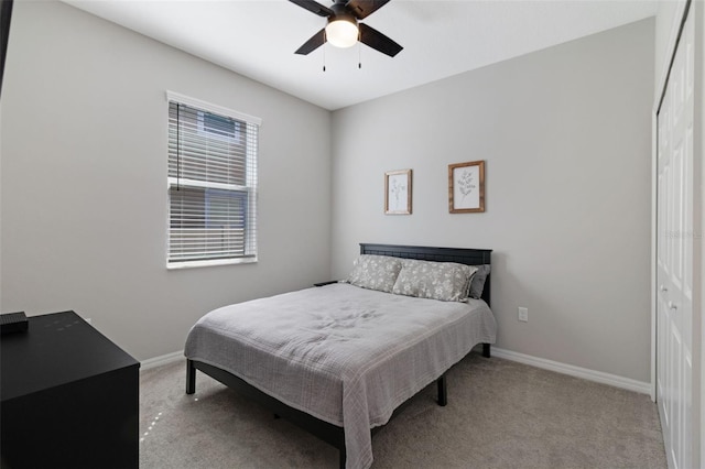 carpeted bedroom with a closet and ceiling fan