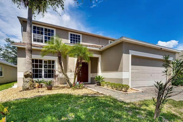 view of front of property with a garage and a front lawn