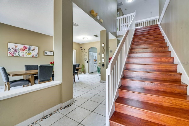 stairway featuring tile patterned floors