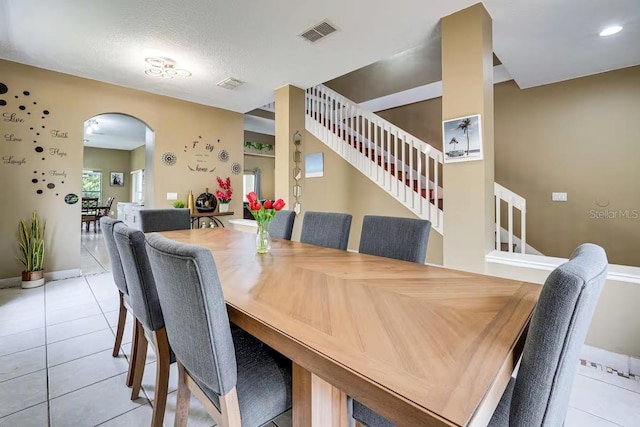 tiled dining room with a textured ceiling