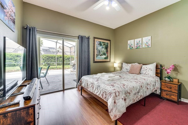 bedroom featuring light wood-type flooring, multiple windows, access to outside, and ceiling fan