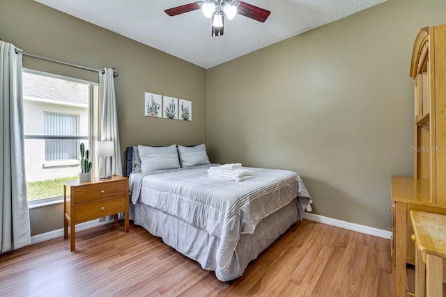 bedroom with light hardwood / wood-style flooring and ceiling fan