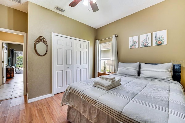 bedroom with a closet, ceiling fan, and light wood-type flooring