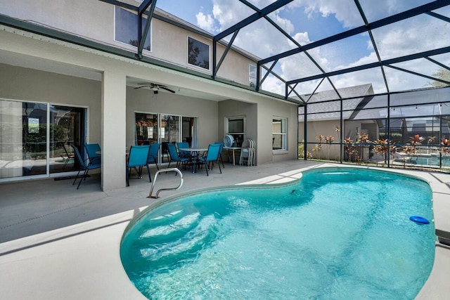 view of swimming pool with a lanai, a patio, and ceiling fan