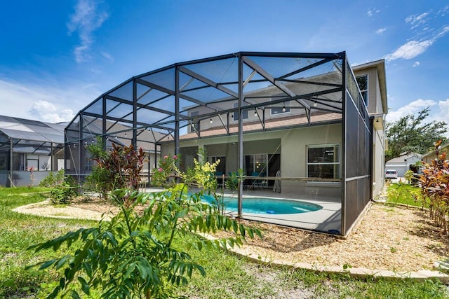 back of property featuring a patio area and a lanai