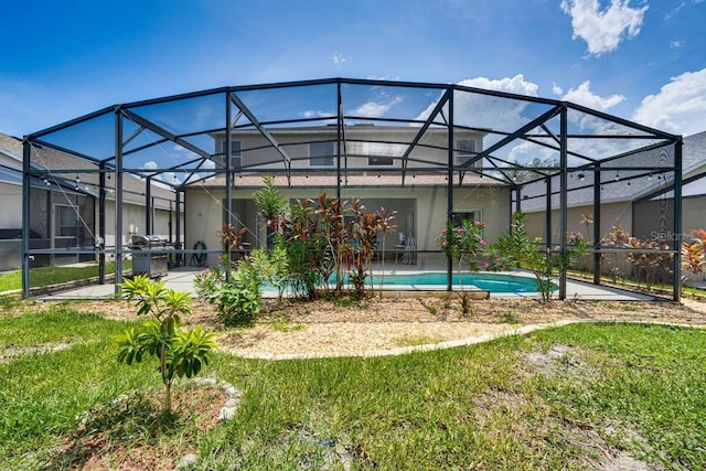 view of swimming pool featuring a patio and a lanai