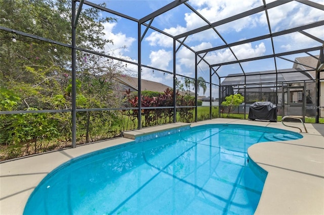 view of swimming pool with a patio and a lanai