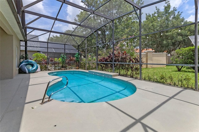 view of pool featuring a patio and glass enclosure