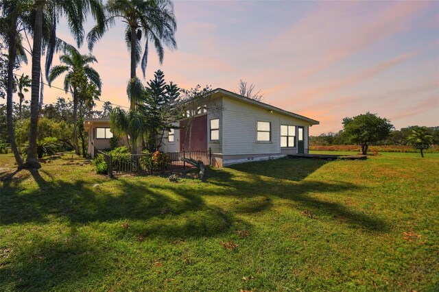 property exterior at dusk with a yard