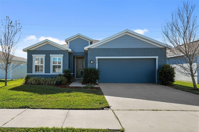 ranch-style house featuring a front lawn and a garage