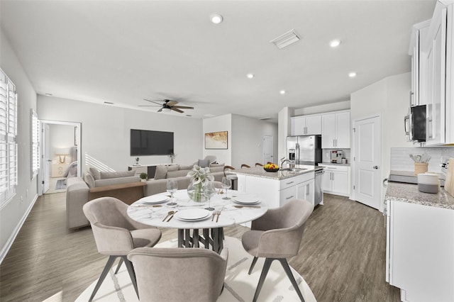 dining space featuring sink, dark hardwood / wood-style flooring, a wealth of natural light, and ceiling fan