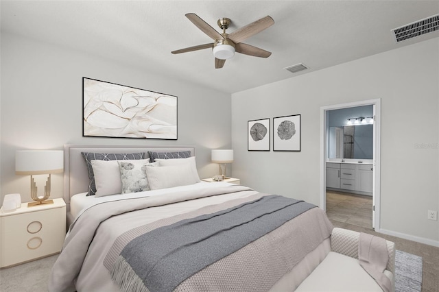 carpeted bedroom featuring ensuite bath and ceiling fan