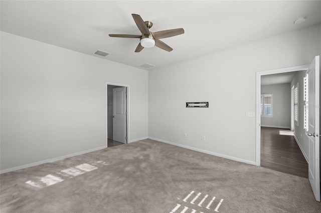 carpeted spare room with ceiling fan