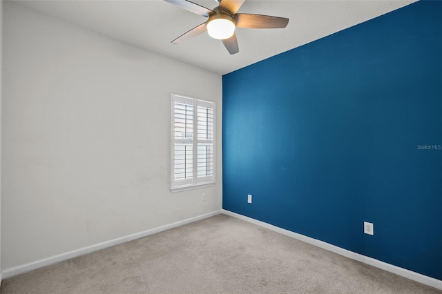 unfurnished room with ceiling fan and light colored carpet