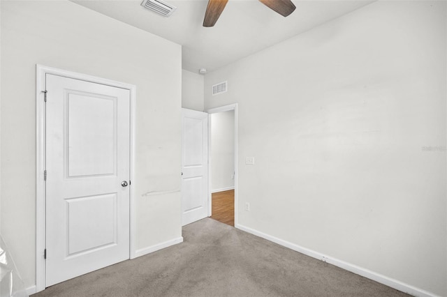 unfurnished bedroom featuring ceiling fan and carpet