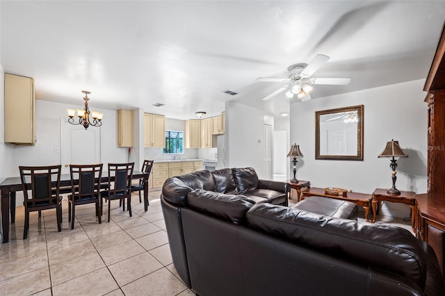 living room with light tile patterned floors and ceiling fan with notable chandelier