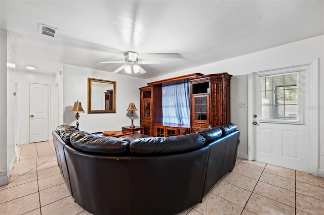 living room featuring light tile patterned floors and ceiling fan