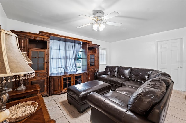 living room with ceiling fan and light tile patterned flooring