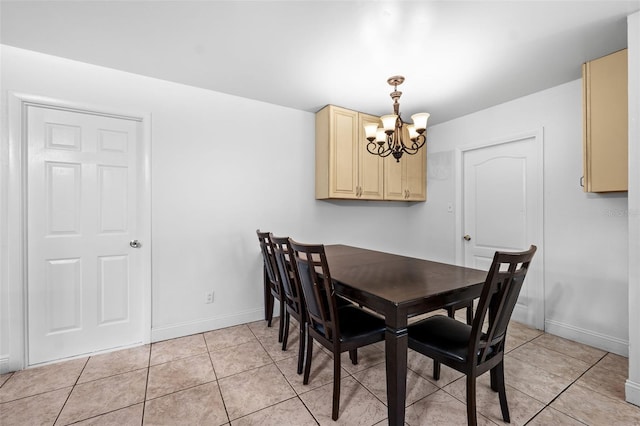 dining space featuring light tile patterned floors and a notable chandelier