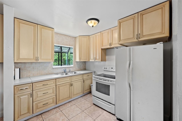 kitchen featuring decorative backsplash, sink, white appliances, and light tile patterned floors