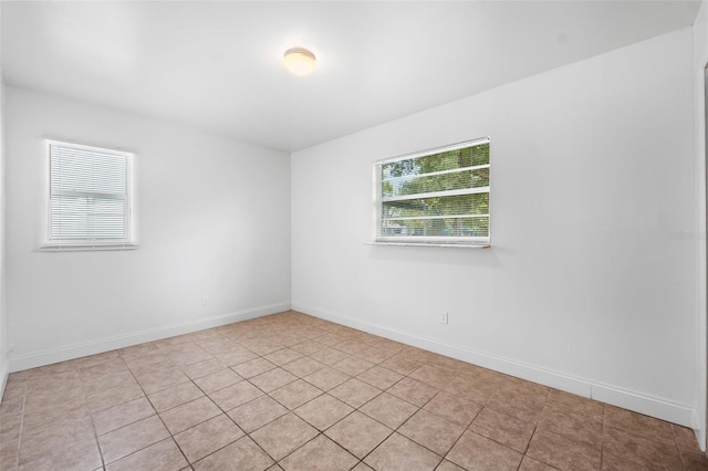 spare room featuring light tile patterned floors