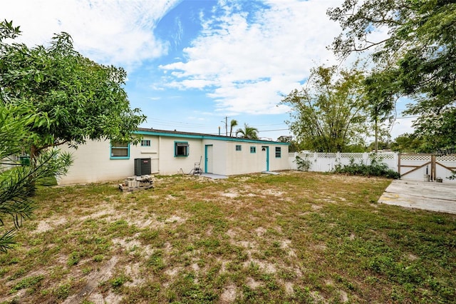 rear view of house featuring a lawn and a patio