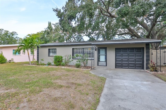 ranch-style house featuring a front lawn and a garage