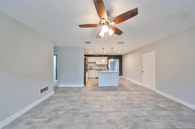 unfurnished living room featuring ceiling fan