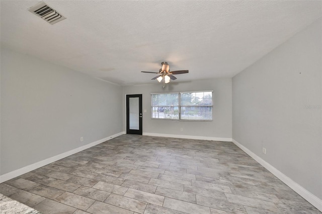 empty room with french doors, a textured ceiling, and ceiling fan