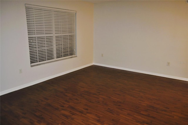 empty room featuring dark wood-type flooring