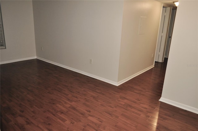 empty room with dark hardwood / wood-style flooring