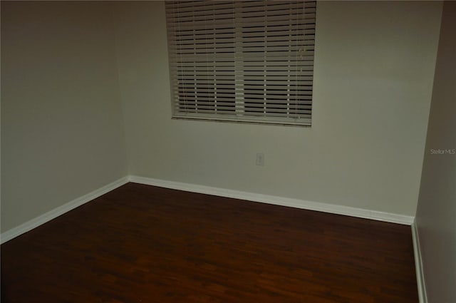 spare room featuring dark hardwood / wood-style flooring