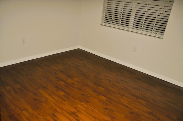 empty room featuring dark hardwood / wood-style flooring