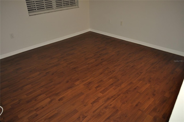 empty room with dark wood-type flooring