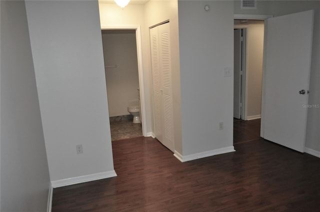 corridor with dark hardwood / wood-style flooring