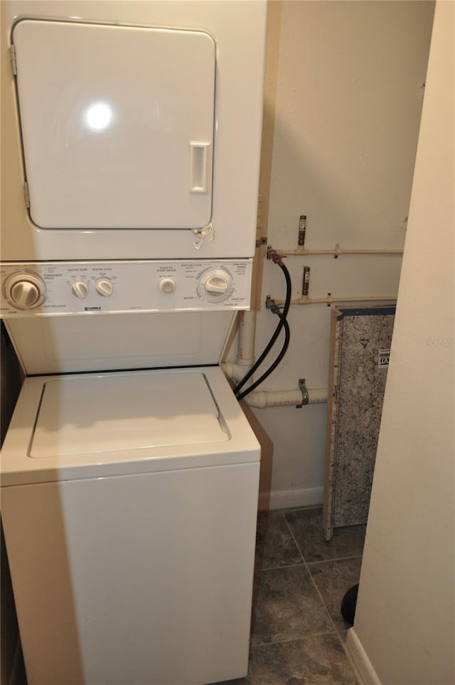 laundry area with stacked washer / drying machine