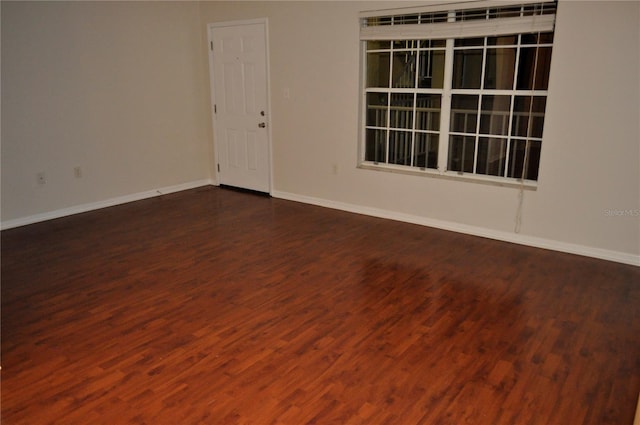 empty room with dark hardwood / wood-style floors