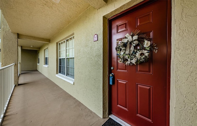 2690 Coral Landings Blvd Unit 722, Palm Harbor, FL 34684 - view of exterior entry with stucco siding and a porch