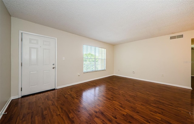 2690 Coral Landings Blvd Unit 722, Palm Harbor, FL 34684 - empty room featuring dark wood-style flooring, baseboards, and a textured ceiling
