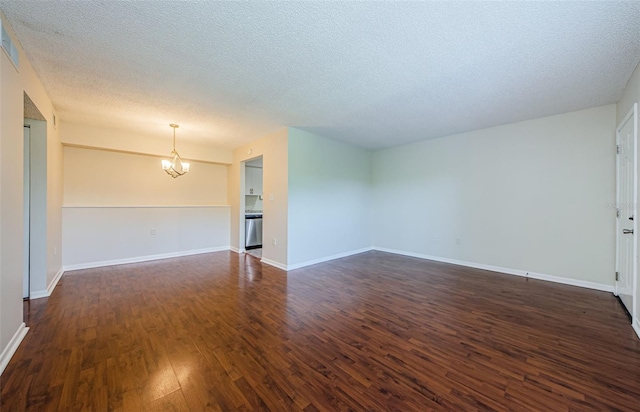 2690 Coral Landings Blvd Unit 722, Palm Harbor, FL 34684 - empty room featuring a chandelier, dark wood-style flooring, a textured ceiling, and baseboards