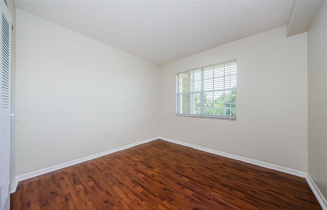 2690 Coral Landings Blvd Unit 722, Palm Harbor, FL 34684 - unfurnished room with dark wood-type flooring and baseboards