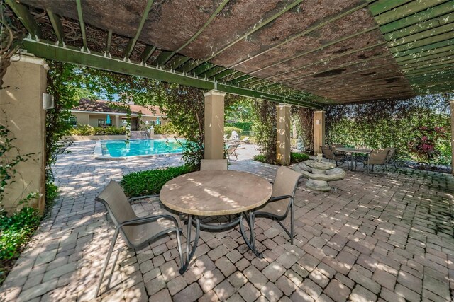 2690 Coral Landings Blvd Unit 722, Palm Harbor, FL 34684 - view of patio featuring outdoor dining space and an outdoor pool