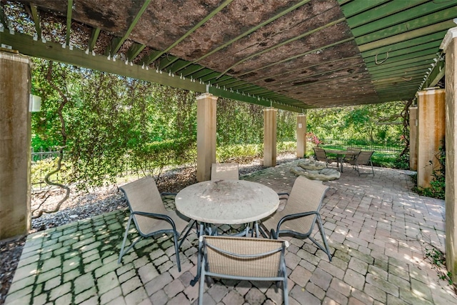 2690 Coral Landings Blvd Unit 722, Palm Harbor, FL 34684 - view of patio / terrace with outdoor dining space and a pergola