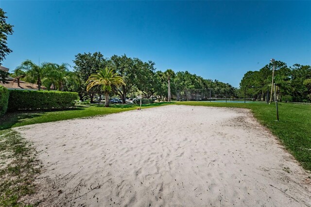 2690 Coral Landings Blvd Unit 722, Palm Harbor, FL 34684 - surrounding community with volleyball court, a lawn, and view of wooded area