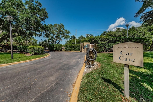 2690 Coral Landings Blvd Unit 722, Palm Harbor, FL 34684 - view of asphalt road with street lighting and curbs